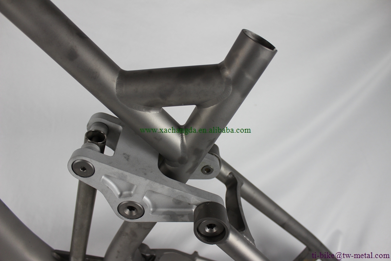 custom titanium suspension bicycle frame with tapered head tube and thru axle dropouts