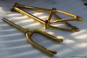 titanium BMX bike frame with integrated head tube in golden color